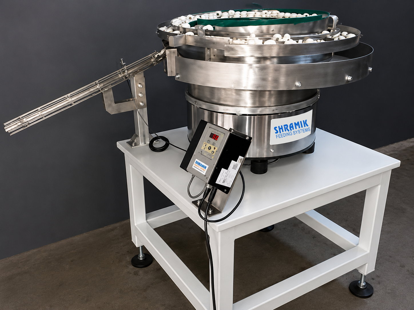 Shramik vibratory bowl feeder with linear feeder mounted on a stand